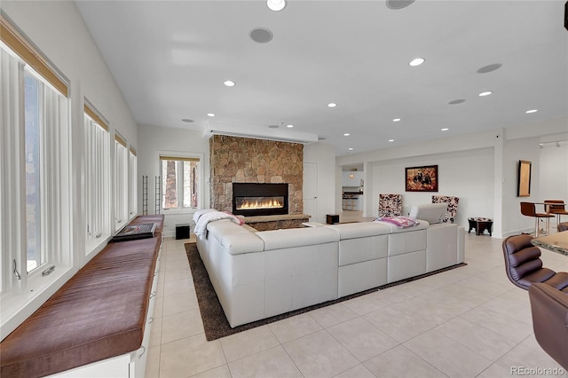 living room featuring light tile patterned floors and a fireplace