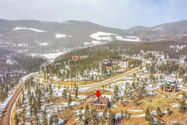 snowy aerial view with a mountain view