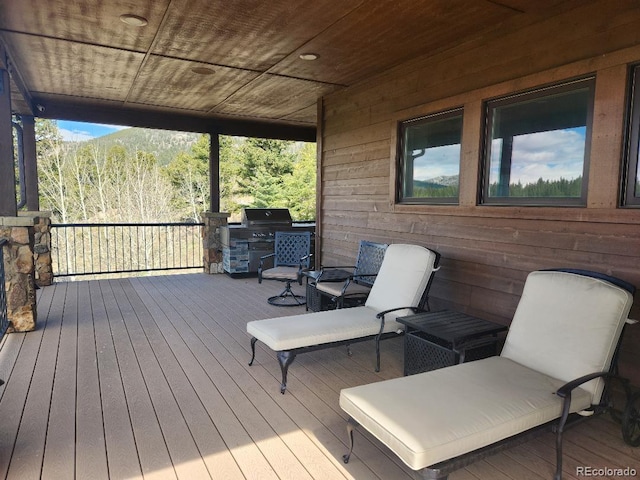 wooden terrace with a grill