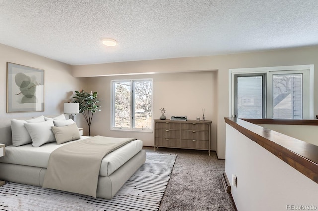 bedroom featuring light carpet and a textured ceiling