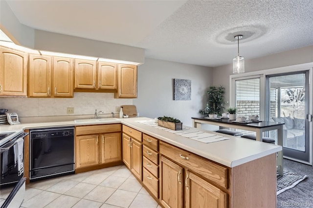 kitchen with light countertops, dishwasher, a peninsula, and a sink