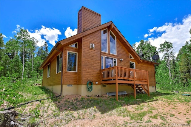 290 Eagle Rock Rd, Florissant, CO 80816 - view of side of property featuring a deck, crawl space, and a chimney