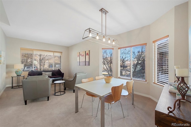 carpeted dining space featuring plenty of natural light