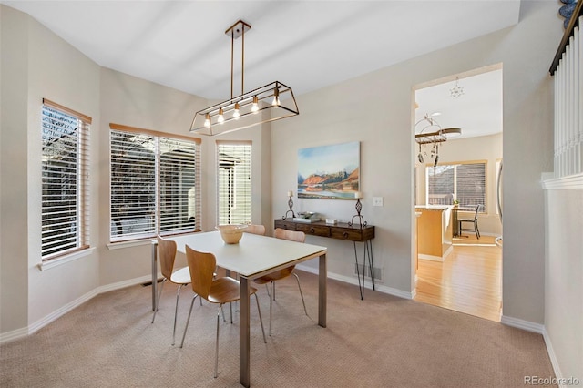 carpeted dining room featuring a healthy amount of sunlight