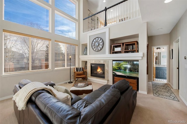 carpeted living room with a high ceiling