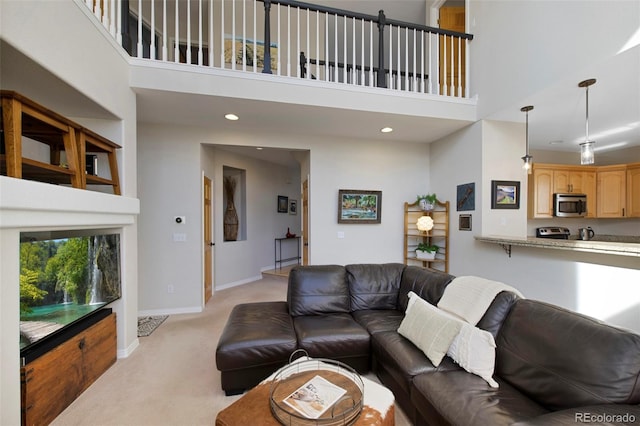 living room featuring a high ceiling and light colored carpet