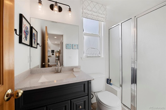 bathroom with vanity, an enclosed shower, and toilet