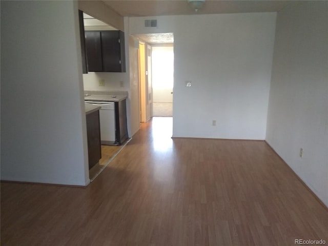 kitchen featuring light wood-style floors, light countertops, and baseboards