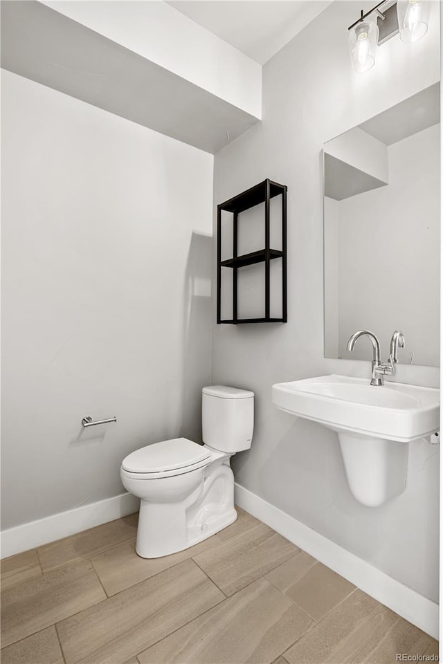 3820 N Olive St Unit 2, Denver, CO 80207 - bathroom featuring toilet and wood finished floors