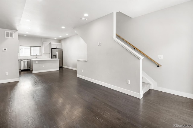 3820 N Olive St Unit 2, Denver, CO 80207 - unfurnished living room featuring dark wood-style floors, recessed lighting, and stairs