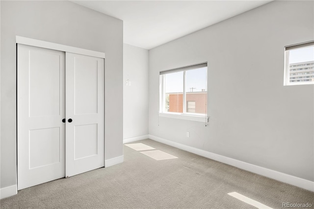 3820 N Olive St Unit 2, Denver, CO 80207 - unfurnished bedroom with multiple windows, carpet floors, and a closet