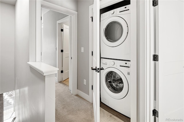 3820 N Olive St Unit 2, Denver, CO 80207 - laundry room with estacked washer and dryer and light carpet