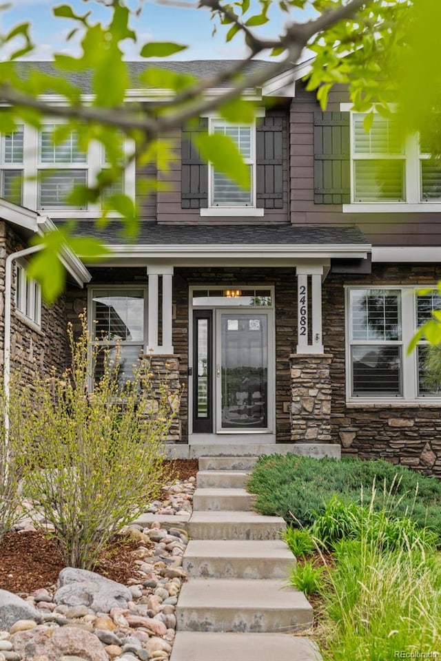24682 E Ontario Dr, Aurora, CO 80016 - property entrance with stone siding and a shingled roof