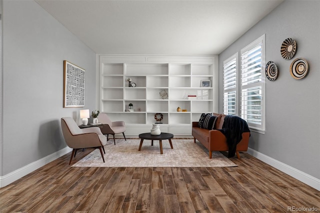 24682 E Ontario Dr, Aurora, CO 80016 - living area with dark wood-style flooring, baseboards, and built in shelves