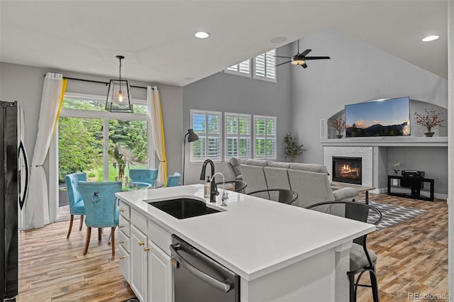 24682 E Ontario Dr, Aurora, CO 80016 - kitchen featuring dishwasher, a sink, freestanding refrigerator, ceiling fan, and light wood finished floors