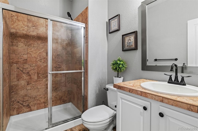 24682 E Ontario Dr, Aurora, CO 80016 - full bathroom featuring a shower stall, toilet, a textured wall, and vanity