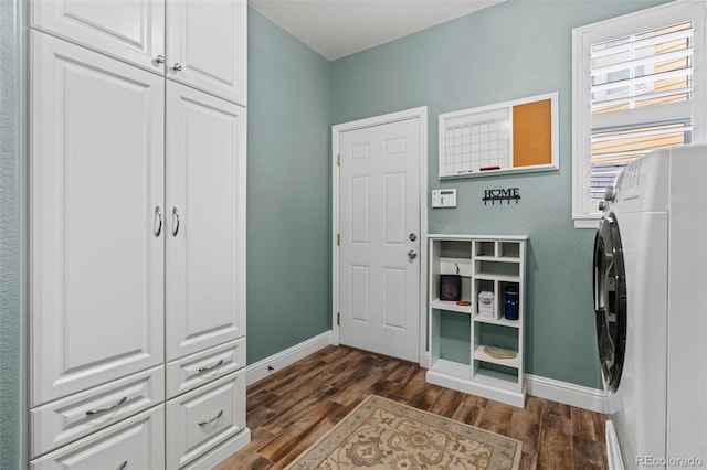 24682 E Ontario Dr, Aurora, CO 80016 - washroom with washer / dryer, cabinet space, dark wood-type flooring, and baseboards