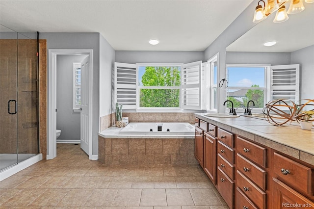 24682 E Ontario Dr, Aurora, CO 80016 - bathroom featuring toilet, vanity, a shower stall, a bath, and tile patterned flooring