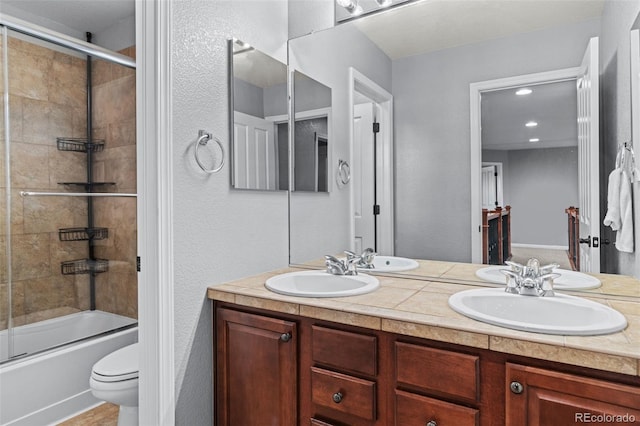 24682 E Ontario Dr, Aurora, CO 80016 - full bath with double vanity, toilet, enclosed tub / shower combo, and a textured wall