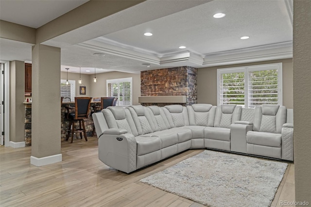 24682 E Ontario Dr, Aurora, CO 80016 - living room featuring plenty of natural light, light wood finished floors, a tray ceiling, recessed lighting, and a textured ceiling