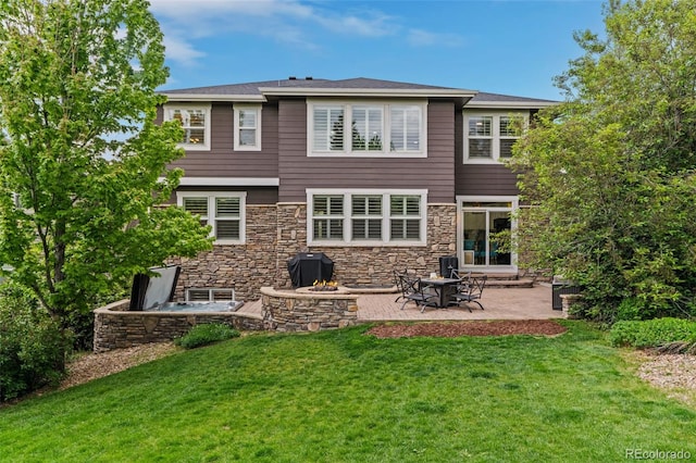 24682 E Ontario Dr, Aurora, CO 80016 - back of property with a lawn, a patio, stone siding, and an outdoor fire pit