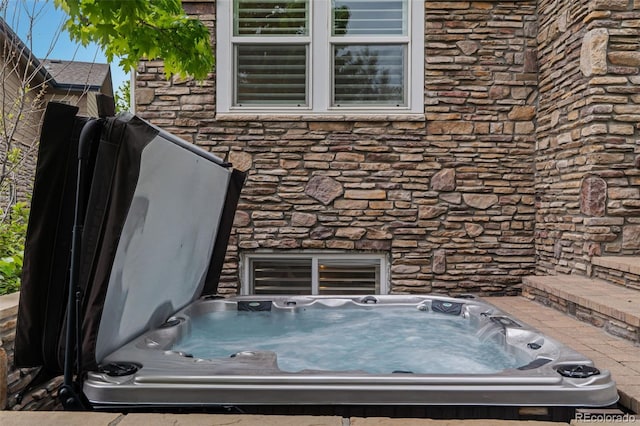 24682 E Ontario Dr, Aurora, CO 80016 - exterior view of stone siding and a jacuzzi