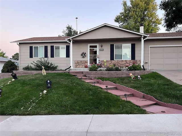 ranch-style home with a lawn and a garage