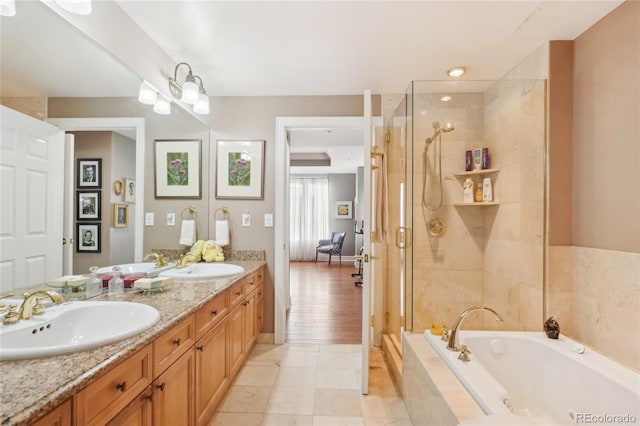 bathroom with tile patterned flooring, vanity, and independent shower and bath