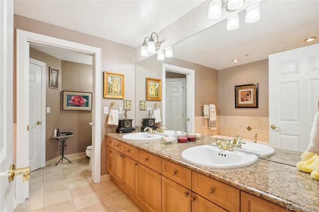 bathroom with tile patterned flooring, vanity, a notable chandelier, and toilet