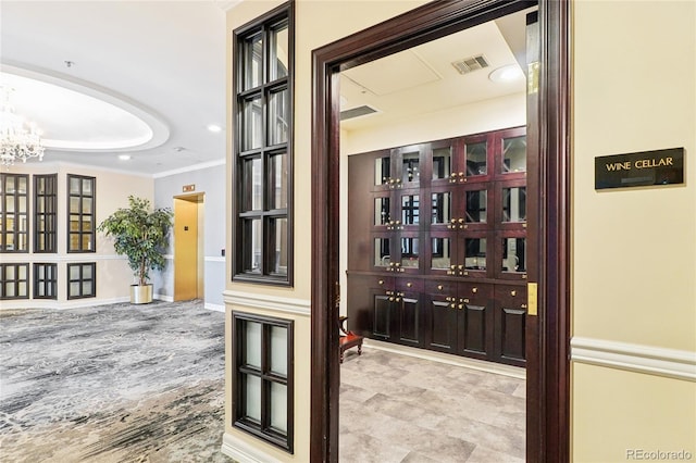 interior space featuring ornamental molding and a notable chandelier