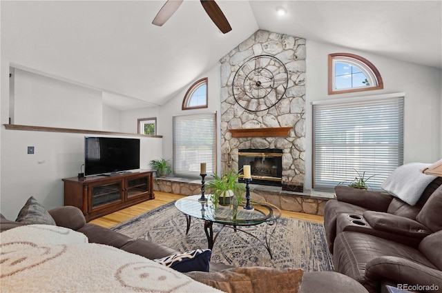 17815 Saddlewood, Monument, CO 80132 - living room featuring vaulted ceiling, wood finished floors, ceiling fan, and a fireplace