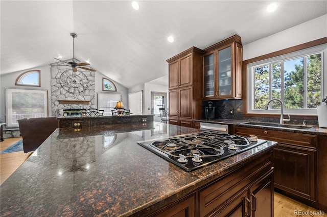 17815 Saddlewood, Monument, CO 80132 - kitchen featuring black gas cooktop, a ceiling fan, open floor plan, plenty of natural light, and lofted ceiling