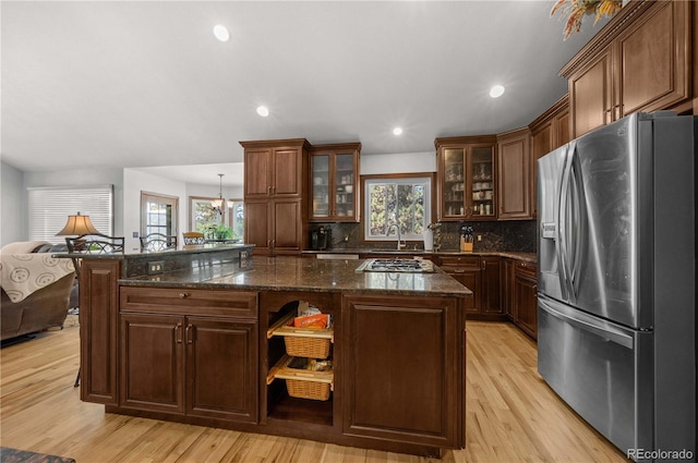 17815 Saddlewood, Monument, CO 80132 - kitchen with stainless steel appliances, healthy amount of natural light, a center island, decorative backsplash, and recessed lighting