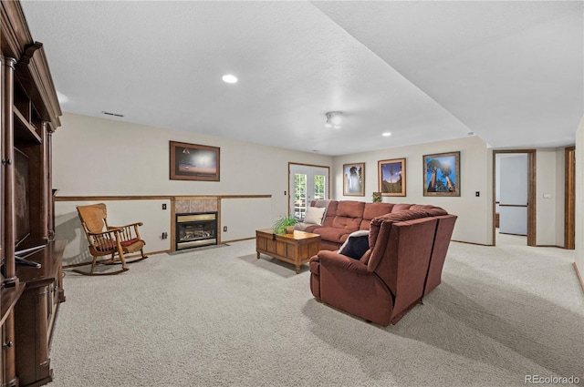 17815 Saddlewood, Monument, CO 80132 - carpeted living room featuring a tile fireplace and recessed lighting