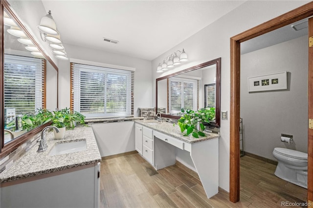 17815 Saddlewood, Monument, CO 80132 - full bathroom with two vanities and wood finished floors