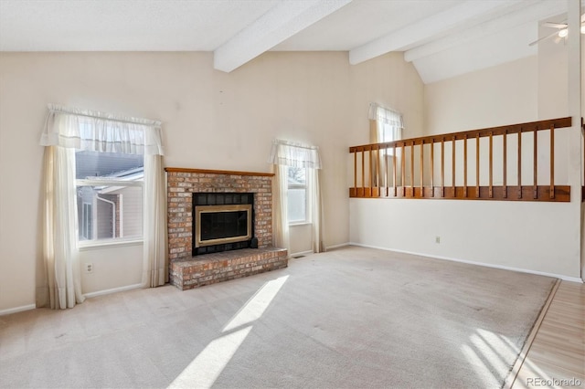 unfurnished living room featuring a brick fireplace, light carpet, lofted ceiling with beams, and ceiling fan