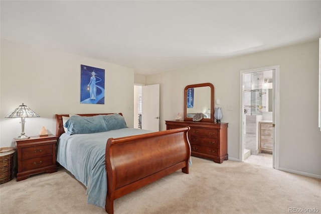 bedroom featuring ensuite bath and light colored carpet