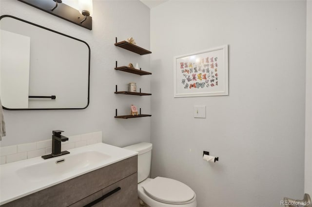 bathroom featuring toilet and vanity