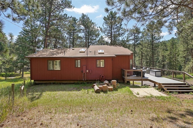 rear view of house featuring a deck