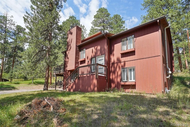 view of side of home featuring a lawn