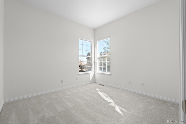 unfurnished room featuring light carpet