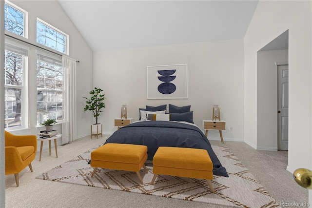 bedroom with high vaulted ceiling and light colored carpet