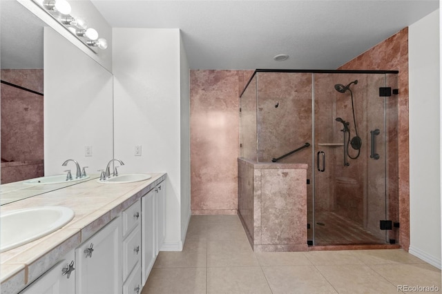 bathroom featuring walk in shower, tile patterned floors, and vanity