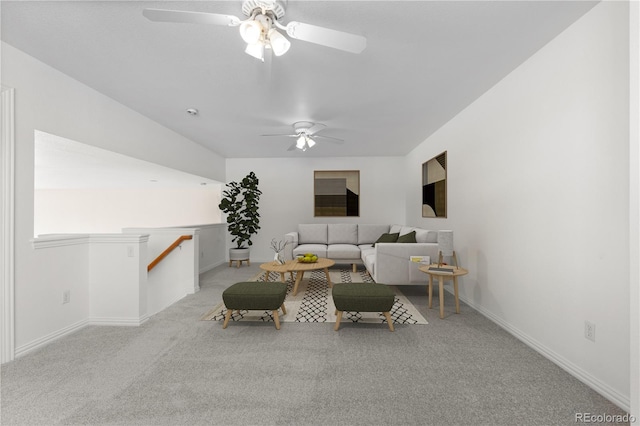 carpeted living room with ceiling fan