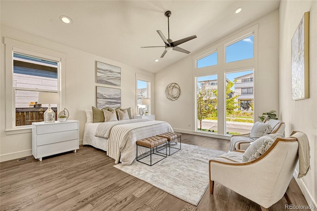 bedroom featuring hardwood / wood-style floors, ceiling fan, and high vaulted ceiling