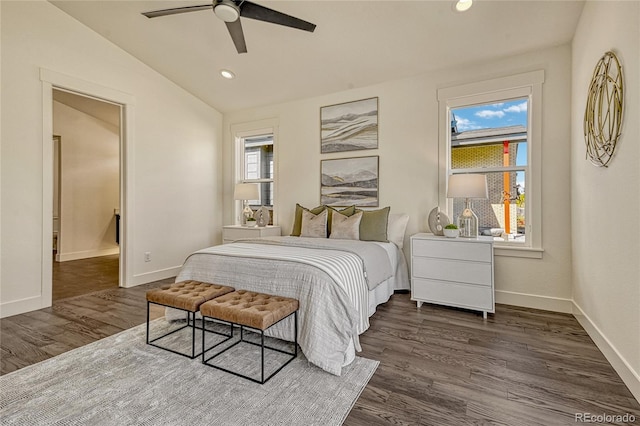 bedroom featuring dark hardwood / wood-style floors, vaulted ceiling, and ceiling fan