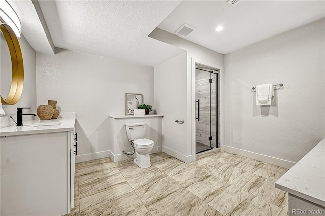 bathroom featuring a textured ceiling, vanity, toilet, and a shower with shower door