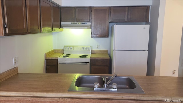 kitchen featuring dark brown cabinets, white appliances, and sink