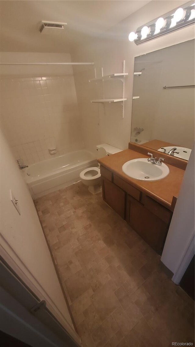 full bathroom with vanity, toilet, and tiled shower / bath