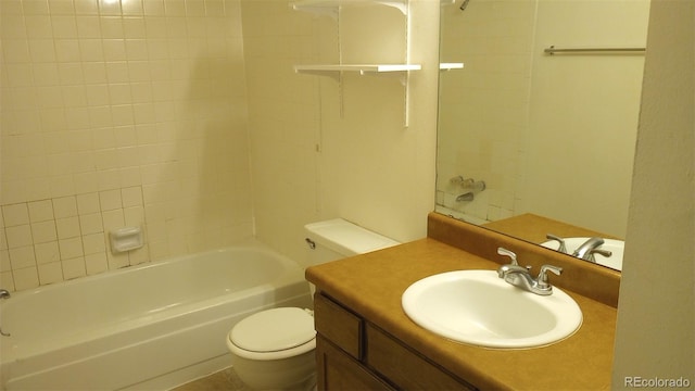 full bathroom with vanity, tiled shower / bath, and toilet